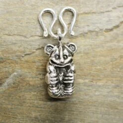 Gripping Bear Pendant -The Viking Dragon ad silver gripping bear pendant on butterfly clasp on rock