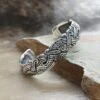 Silver Viking Raven Arm Ring -The Viking Dragon ad silver viking raven bracelet arm ring on rock angle view