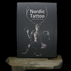 Nordic Tattoo Book - Hardcover - 5th Edition By Kai Uwe Faust -The Viking Dragon bk nordic tattoo book front on rock