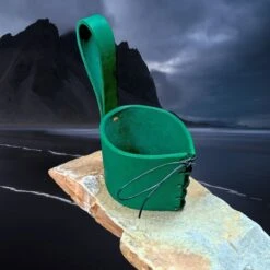Viking Drinking Horn Leather Belt Hanger -The Viking Dragon bt green leather horn hanger on rock