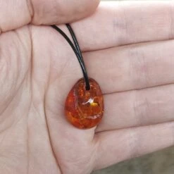 Amber Amulet Pendant -The Viking Dragon eg medium amber amulet pendant on hand
