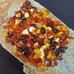 Polished Amber Chips With Drilled Holes -The Viking Dragon eg polished amber beads on rock x 50g