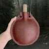 Large Handmade Leather Water Bottle -The Viking Dragon lo large brown leather water bottle with strap round shape in hand