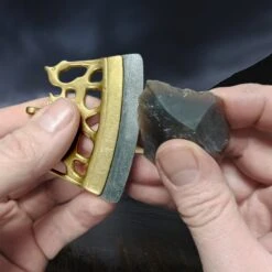 Bronze Finnish Fire Striker With Flint Flake -The Viking Dragon mc bronze viking age fire steel from finland in fingers with flint