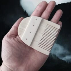 Rounded Bone Viking Comb -The Viking Dragon nc bone comb rounded in flat full hand
