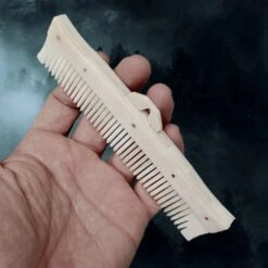 Long Decorated Bone Viking Comb With Hanger -The Viking Dragon nc long bone comb with rivets in hand side angle view