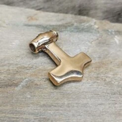 Bronze Filigree Thors Hammer Pendant From Kabara -The Viking Dragon sn bronze kabara thors hammer on rock back angle view