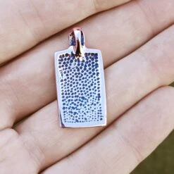 Bronze Jelling Serpent Pendant -The Viking Dragon sn bronze rectangular jelling pendant on hand back view