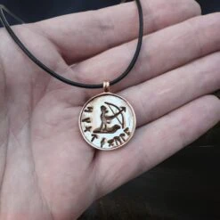 Bronze Skadi Ull Viking Pendant 11 Bronze Skadi Ull Viking Pendant -The Viking Dragon sn bronze skadi ull pendant on leather thong on hand