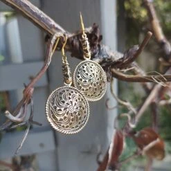 Bronze Gotland Sun Wheel Earrings -The Viking Dragon sn bronze sunwheel earrings with dragon heads hanging in tree