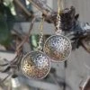 Bronze Gotland Sun Wheel Earrings -The Viking Dragon sn bronze sunwheel earrings with dragon heads hanging in tree front view