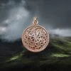 Bronze Sun Wheel Pendant -The Viking Dragon sn bronze sunwheel pendant on cloudy hills background