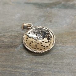 Bronze Sun Wheel Pendant -The Viking Dragon sn bronze sunwheel pendant on rock back view