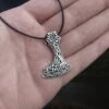 Silver Bearded Axe Head Pendant -The Viking Dragon sn silver bearded axe head pendant on leather thong on hand