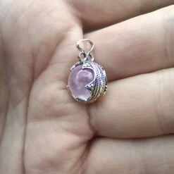 Small Silver Gotland Rose Quartz Ball Pendant -The Viking Dragon sn silver gotland ball pendant rose quartz crystal on hand angle view