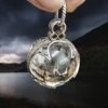 Large Silver Gotland Crystal Ball Pendant 2 Large Silver Gotland Crystal Ball Pendant -The Viking Dragon sn silver large gotland crystal ball pendant in fingers angle view