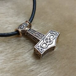 Bronze Odeshög Thors Hammer Pendant -The Viking Dragon wl bronze oseberg thors hammer on fur side view