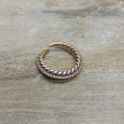 Bronze Braided Viking Ring -The Viking Dragon wl twisted bronze viking ring on rock front angle view